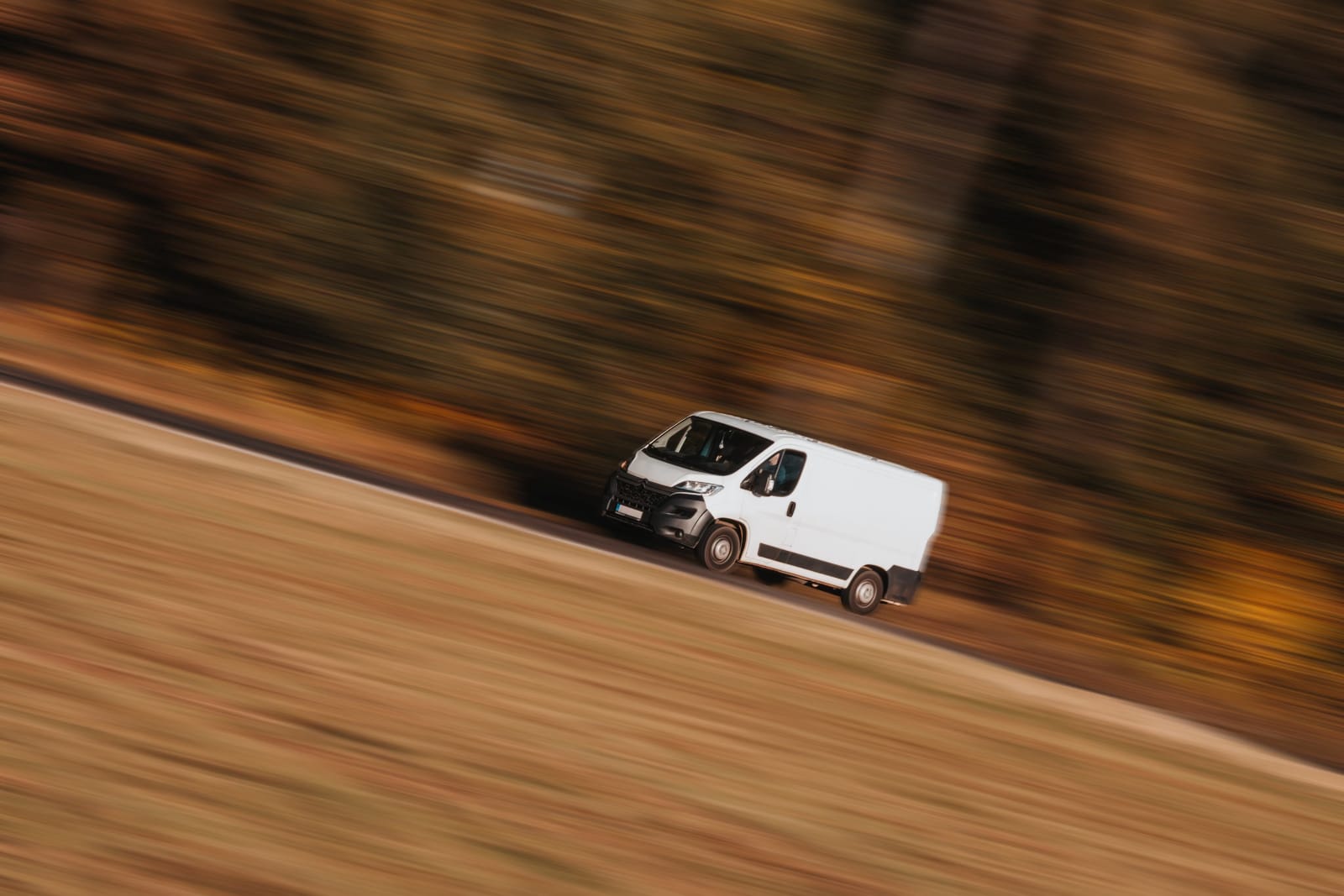 Compact image of a speeding delivery truck showcasing Droppath's main advantage compared to competitors